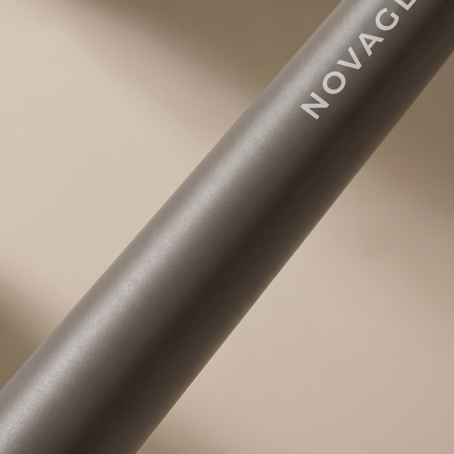 NOVAGLOW makeup brush handle closeup showing smooth matte finish